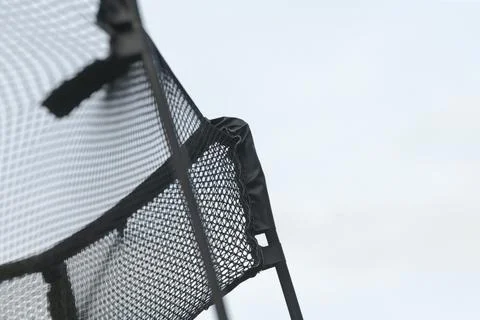 Texture and stitching of trampoline net against sky background 库存照片