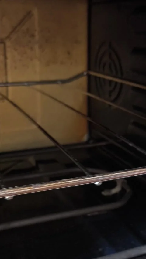 The texture and structure of fat and dirt on a long-unwashed stove and oven Stock Footage 313186675