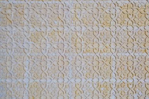 Texture arabic pattern on the stone wall. Orange floral background. Texture w Stock Photos