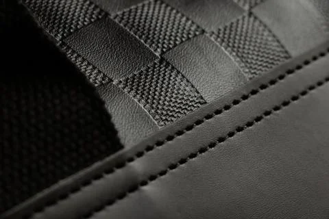 Texture of artificial leather with embossing and seams on a men's black bag c Stock Photos