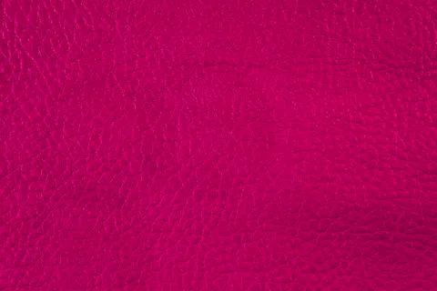 Texture of artificial leather. Red saturated color background. Stock Photos