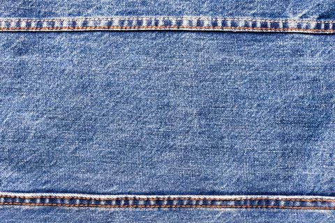 Texture backdrop photo of blue colored denim cloth. Stock Photos