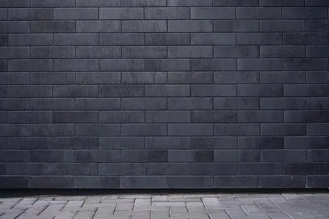 Texture background of brick wide wall painted in dark gray and black color Stock Photos