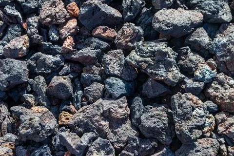 Texture background of dark volcanic lava stones Stock Photos