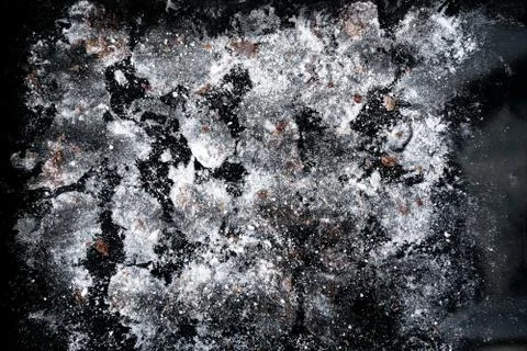 Texture background from icing sugar, crushed cookies and chocolate on a black Stock-Fotos