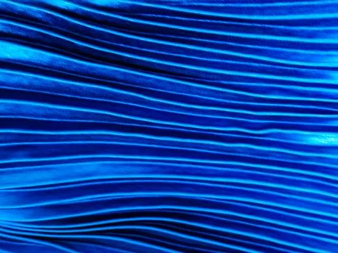 Texture, background, pattern, Cloth pleated blue. A shiny finished folded sat Stock Photos