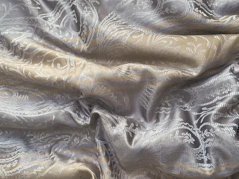 Texture, background, pattern- draped silk yellow-gray fabric with matte-glossy 스톡 사진