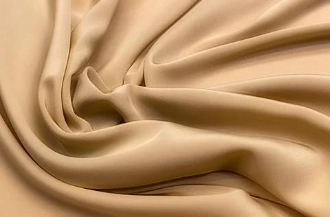 Texture, background, pattern. Texture of beige silk or cotton or wool fabric. Stock Photos