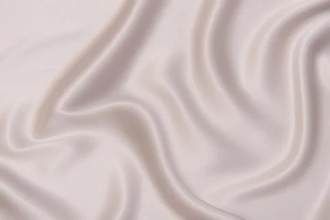 Texture, background, pattern. Texture of peach or beige silk or cotton fabric Stock Photos