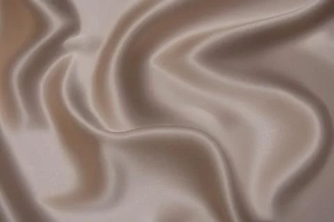 Texture, background, pattern. Texture of peach or beige silk or cotton fabric Stock Photos