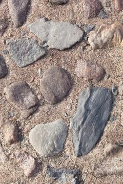 Texture, background. The pavement of granite stone. Old cobblestone road pave Stock Photos