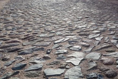 Texture, background. The pavement of granite stone. Old cobblestone road pave Stock Photos