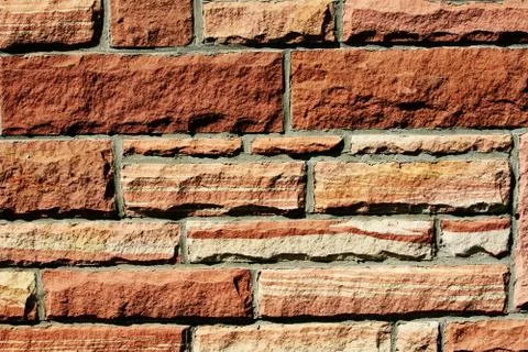 Texture background of a red sandstone wall. Stock Photos