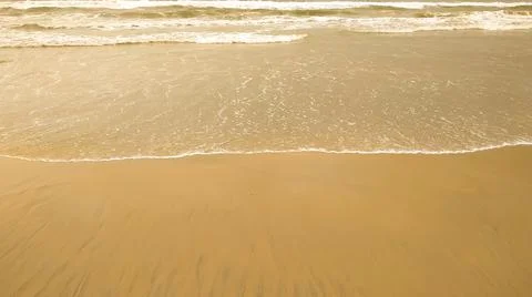 Texture background of sandy beach with gentle soft waves Stock-Fotos