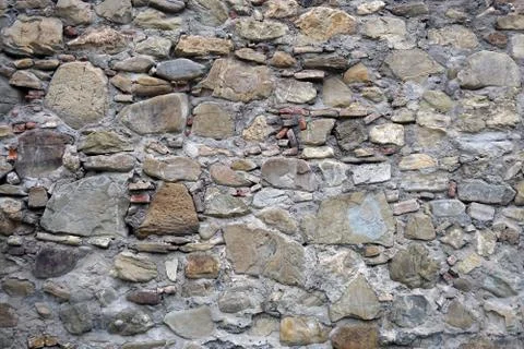 Texture, background of stones  different sizes and colors  the walls 库存照片
