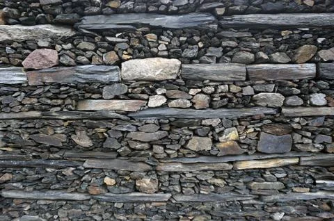 Texture, background of stones  different sizes and colors  the walls 库存照片