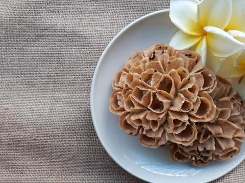 Texture background of Thai snacks name "kanom dork jork" on a dish with flowers. Stock Photos
