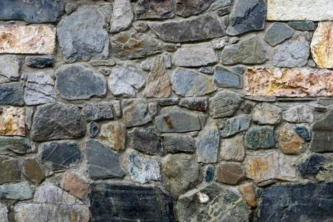 Texture, the background of the wall lined with natural stones  different shap Photos