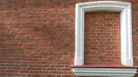 Texture background. White frame on the red brick wall Foto stock