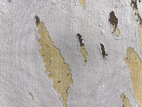 Texture background of White Paint Peel off on Yellow Wall Stock Photos