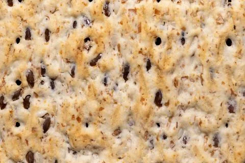 Texture background of whole grain crispbread with flax seeds macro 스톡 사진
