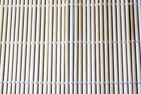 Texture of bamboo rug with knitted threads Stock Photos