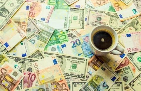 Texture of banknotes and a cup of coffee. Money. Stock Photos