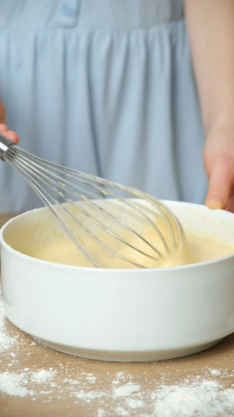 Texture of batter for baking, dough dripping from whisk close-up. Video stock 325109049