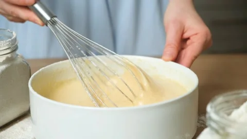 Texture of batter for baking, dough dripping from whisk close-up. Video stock 325190713