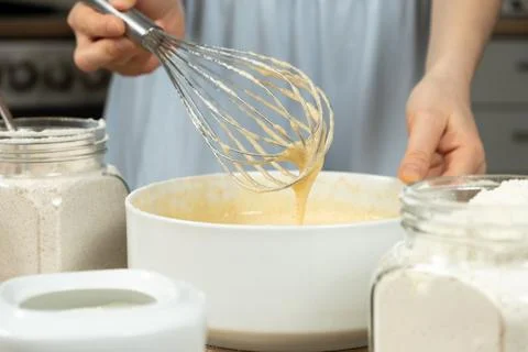 Texture of batter for baking, dough dripping from whisk close-up. Stock Photos