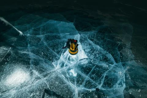 Texture of beautiful blue ice with cracks and air bubbles in the frozen lake Stock Photos