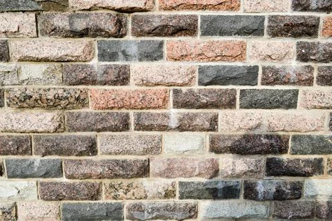 Texture of beautiful multi-colored rectangular bricks, tiles from natural mar Stock Photos