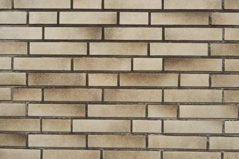 Texture of a beige brick wall Stock Photos