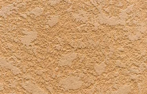 Texture of beige decorative plaster on the wall in the interior of the room. Stock Photos