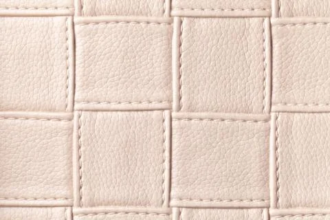 Texture of beige leather background with square pattern and stitch, macro. Stock Photos