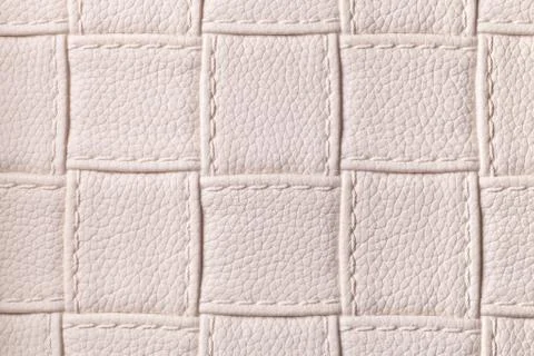 Texture of beige leather background with square pattern and stitch, macro. Foto stock