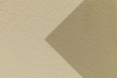 Texture beige paper background, half two colors with brown arrow, macro. Stock Photos