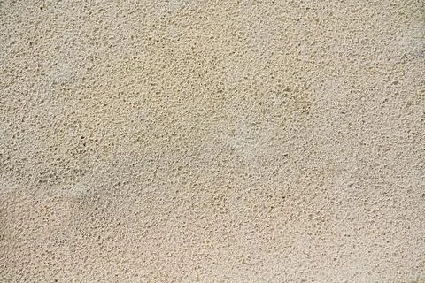Texture of beige sand surface after rain. Stock Photos