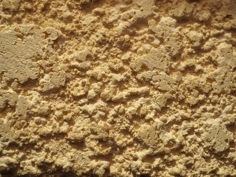 Texture of beige stone decorative plaster or wall. Abstract background for de 库存照片