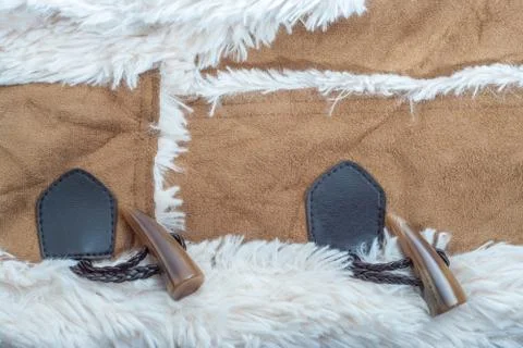 Texture beige suede with artificial soft fur and toggle buttons fastening clo Stock Photos