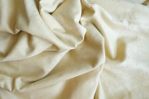 Texture of beige textile material in a fold for background Stock Photos