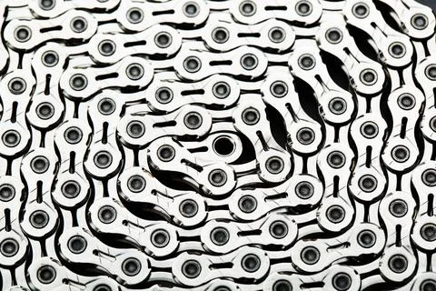 The texture of a bicycle chain is a close-up of the torque transmission links Stock Photos