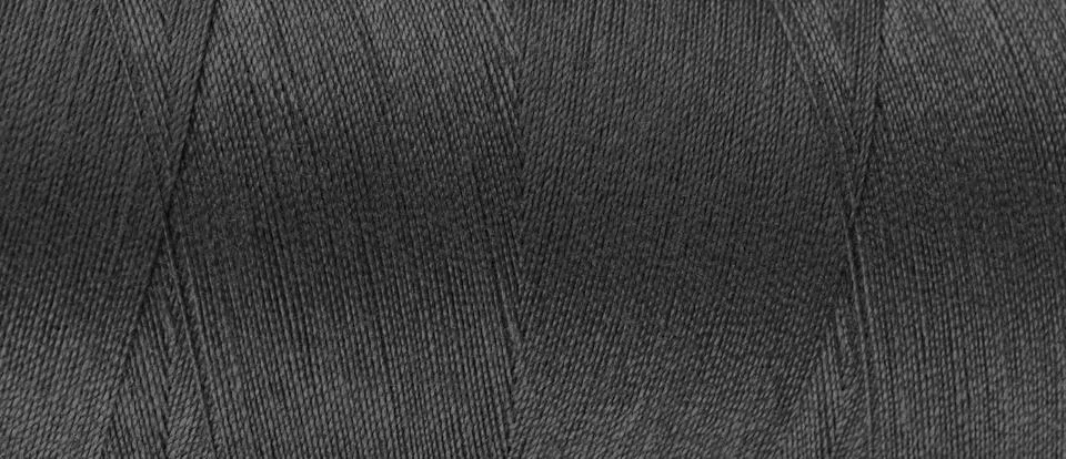 Texture of black color threads in spool close up, macro. Wide banner, header Foto stock