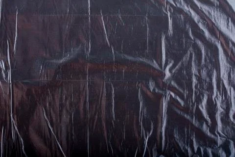 Texture of black crumpled garbage plastic bag. Abstract background for design Stock Photos