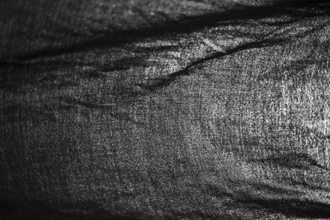 The texture of black fabric. Light through the fabric. Stock Photos