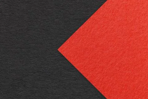 Texture of black paper background, half two colors with red arrow, macro. Stock Photos