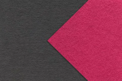 Texture black paper background, half two colors with purple arrow, macro. Stock Photos