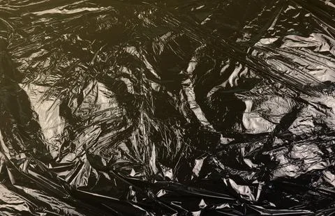 Texture of black plastic garbage disposable bag 스톡 사진