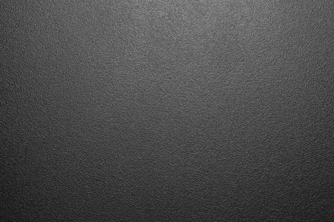 The texture of black rough plastic.Matte black plastic.Plastic rough surface. Stock Photos