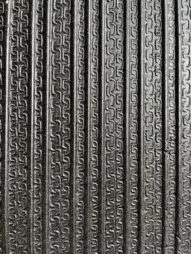 Texture of black rubber mat surface with vertical grooved pattern for non-slip Stock Photos